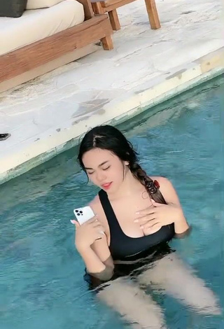 3. Luscious Angguncantik Shows Cleavage in Black Swimsuit at the Swimming Pool