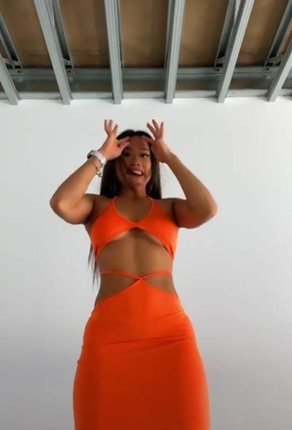 Titillating Sarah Magusara in Orange Dress