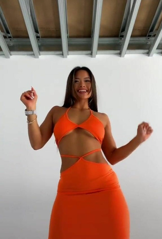 3. Titillating Sarah Magusara in Orange Dress