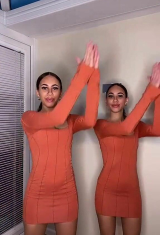 4. Sultry Nel.Twinnys in Orange Dress