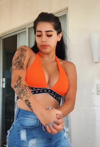 Amazing Kim Shantal Shows Cleavage in Hot Orange Crop Top