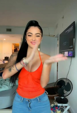 Cute Malu Trevejo Shows Cleavage in Orange Top