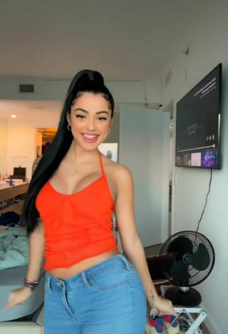 2. Cute Malu Trevejo Shows Cleavage in Orange Top