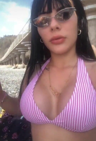 2. Titillating Natalia Shows Cleavage in Striped Bikini Top