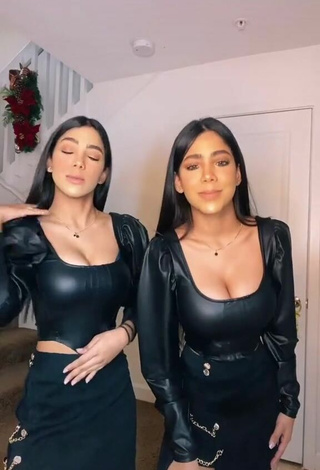 Sultry Melanie & Meila Shows Cleavage in Black Bodysuit