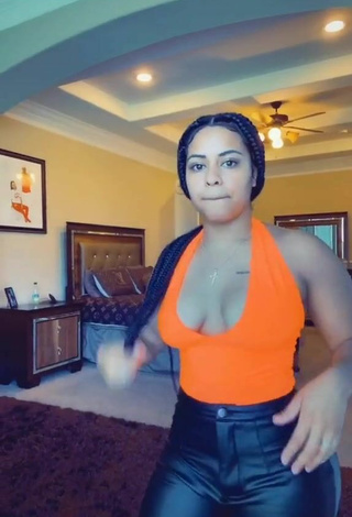 Luscious Carmen Pritchett Shows Cleavage in Electric Orange Top