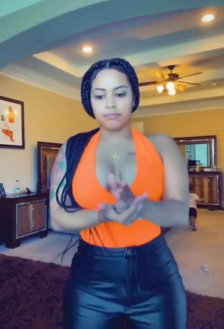 2. Luscious Carmen Pritchett Shows Cleavage in Electric Orange Top